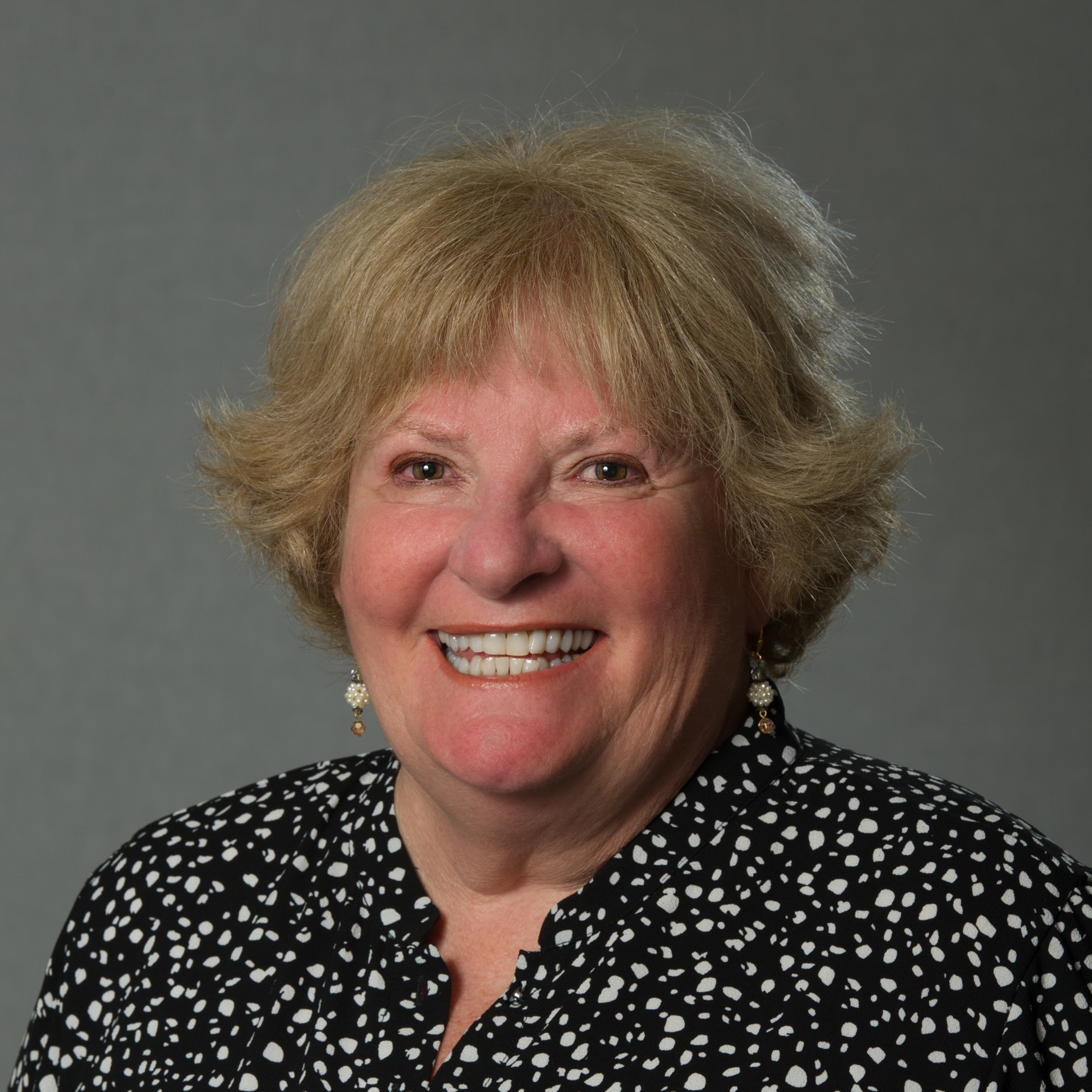 Headshot of Patricia Hassard wearing a polka dot blouse