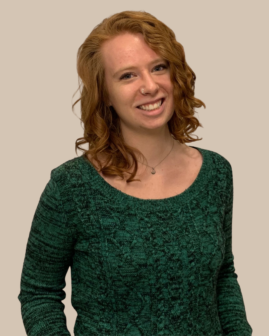 Katerine Draper Board of Directors - A young white woman with brunette hair wearing a green dress