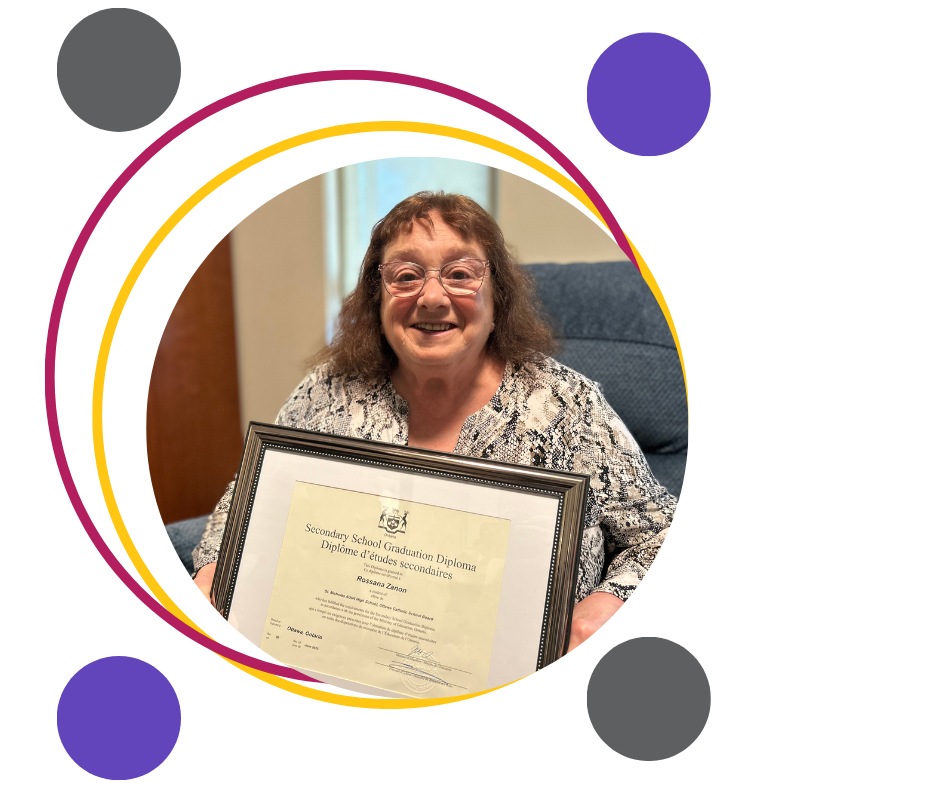 ROssana-at-Princeton-ROom-with-diploma-in hand sitting on a chair